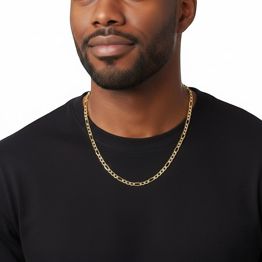 TYS Jewelers 10K yellow gold two-tone diamond-cut figaro chain worn by a man in a black crew neck shirt.
