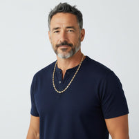 A man wearing a TYS Jewelers 10K gold trio color Valentino chain against a plain white background.