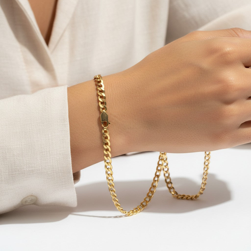 TYS Jewelers 10K yellow gold curb Cuban chain worn on a wrist, showcasing the polished solid gold link design.