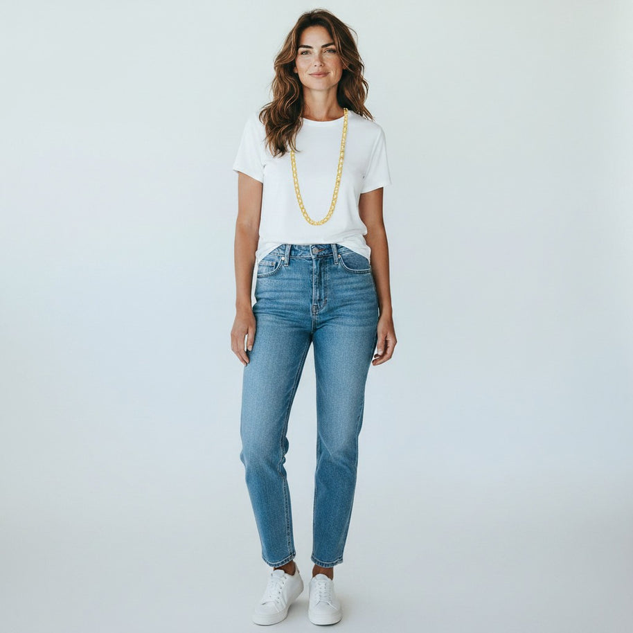 Woman wearing a TYS Jewelers 10K yellow gold mariner chain with a white t-shirt and blue jeans